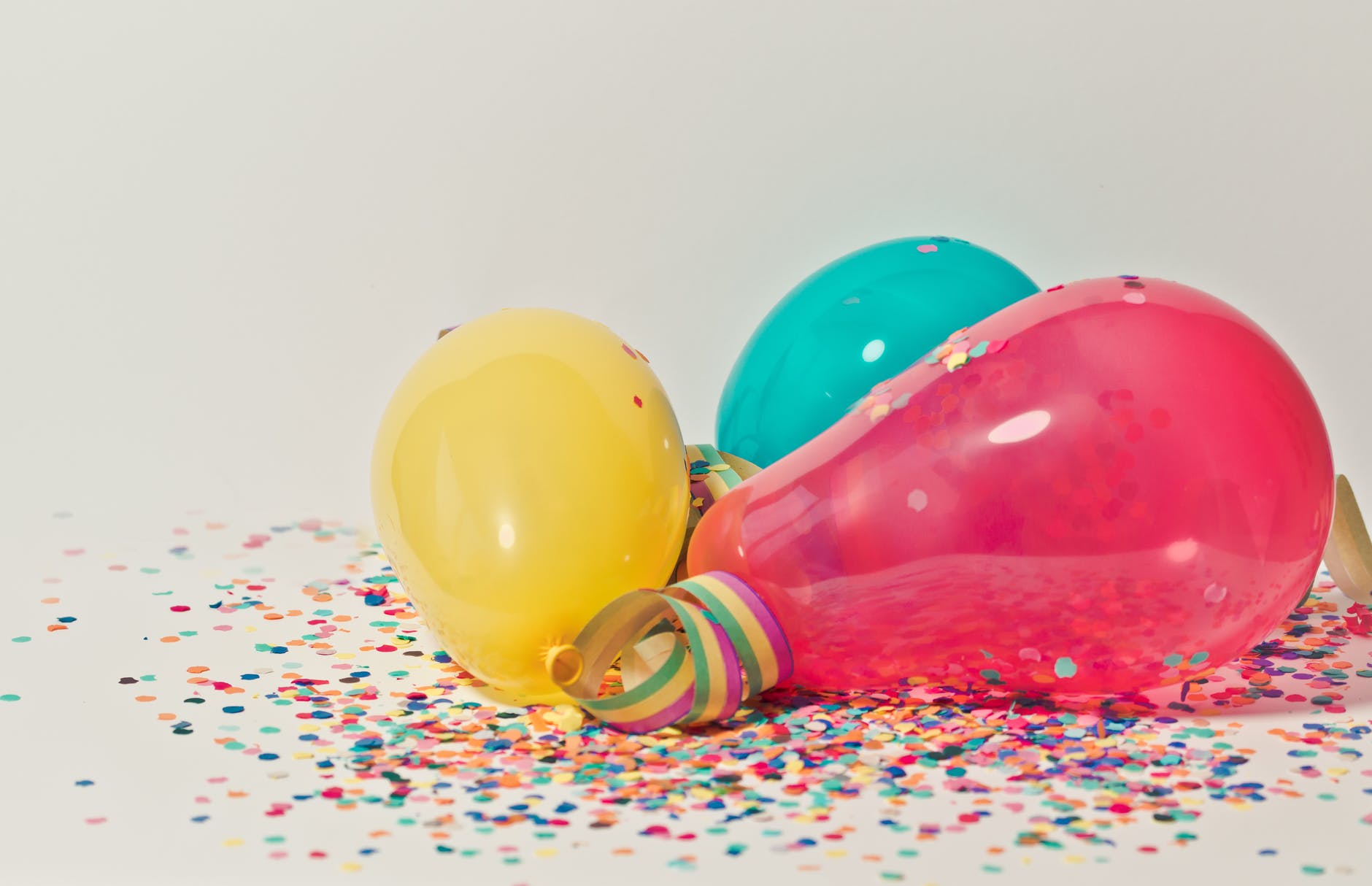 yellow pink and blue party balloons